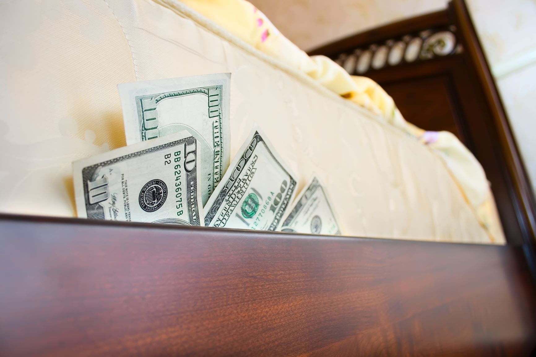 Hundred dollar bills stuffed under a mattress.